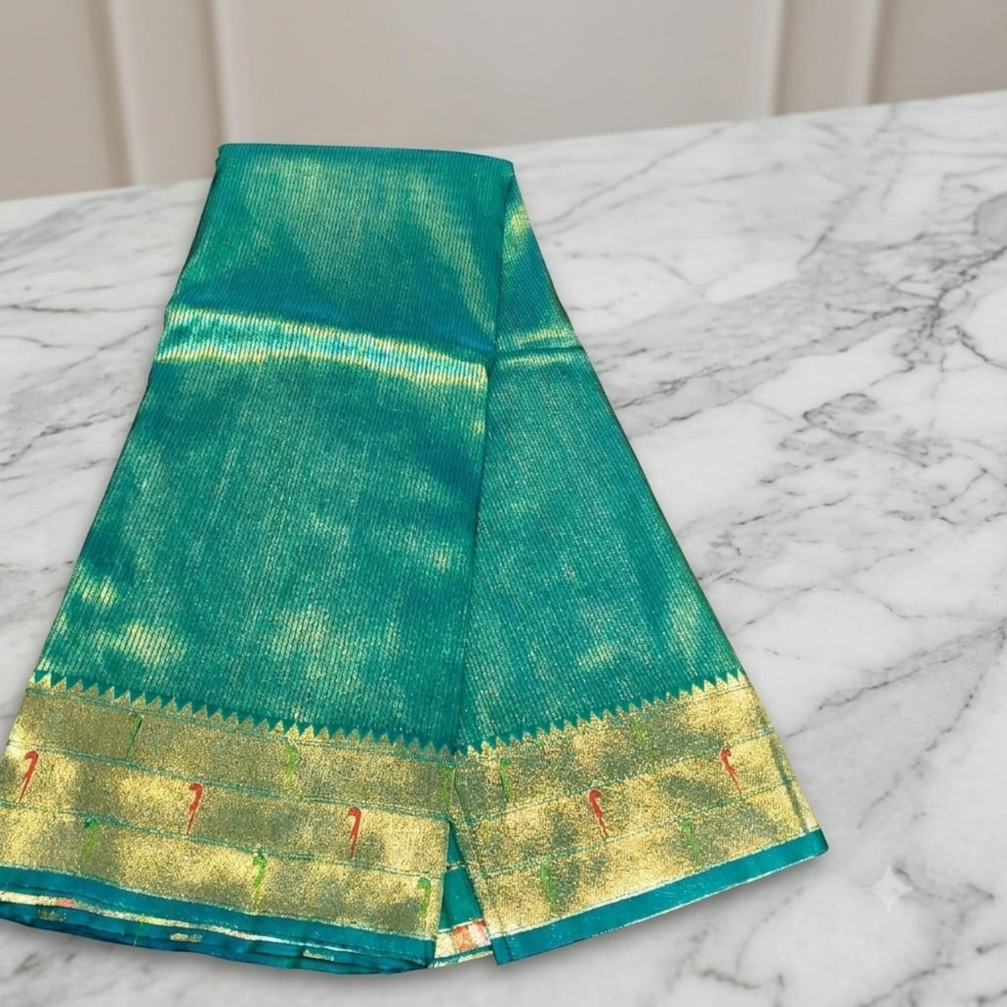 City Center green silk Muniya Paithani saree with gold zari border and traditional parrot motifs on a marble surface