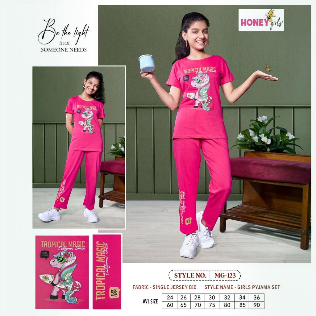 City Center Honey Girls pink cotton cord set with unicorn graphic print, worn by a smiling girl with white sneakers.