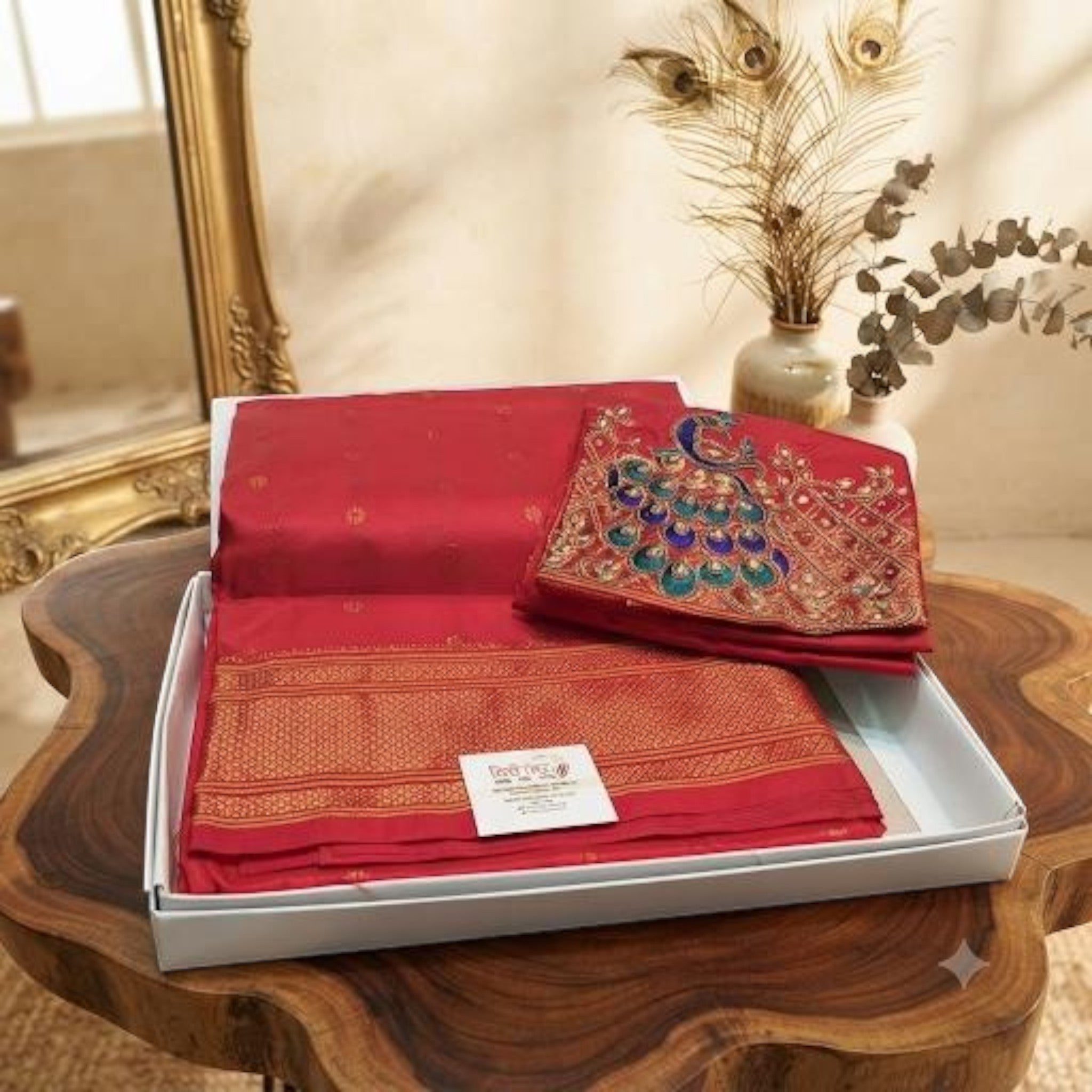 City Center Kalanjali Aari work red saree with intricate peacock embroidery and gold border in a gift box