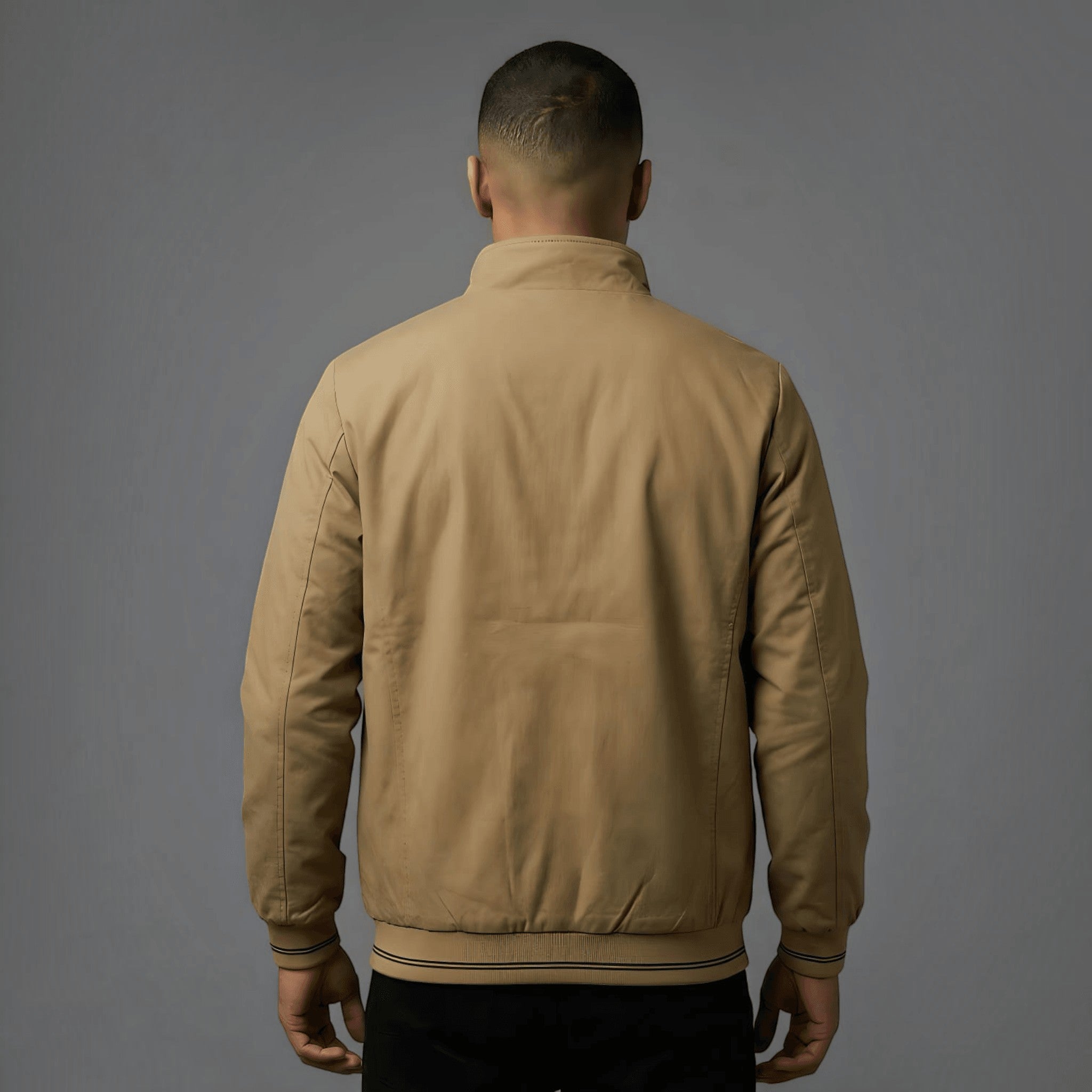 City Center khaki reversible parachute jacket worn by a man, back view showing ribbed cuffs and professional fit.