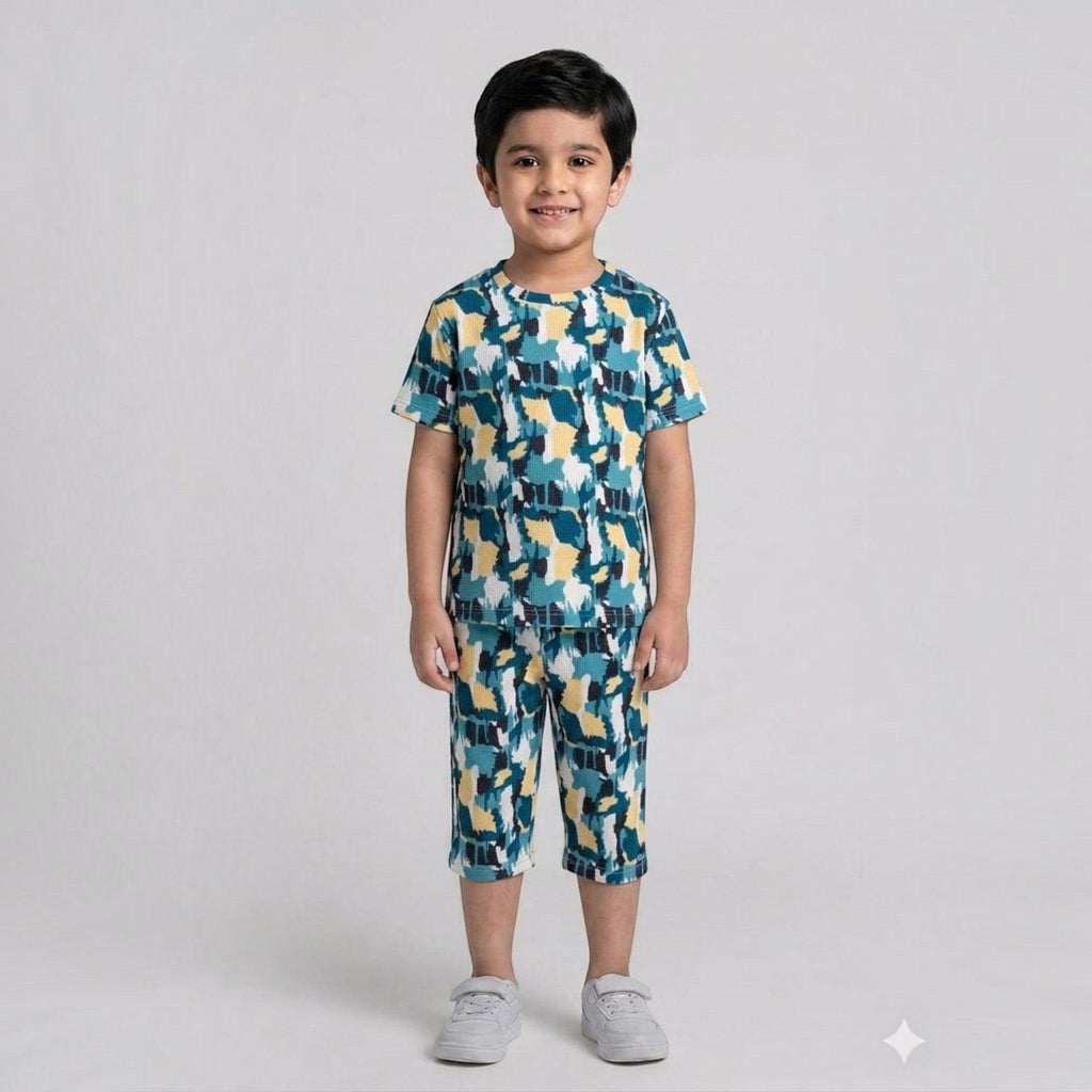 City Center kids cotton co-ord set with a blue and yellow abstract print worn by a smiling boy on a white background