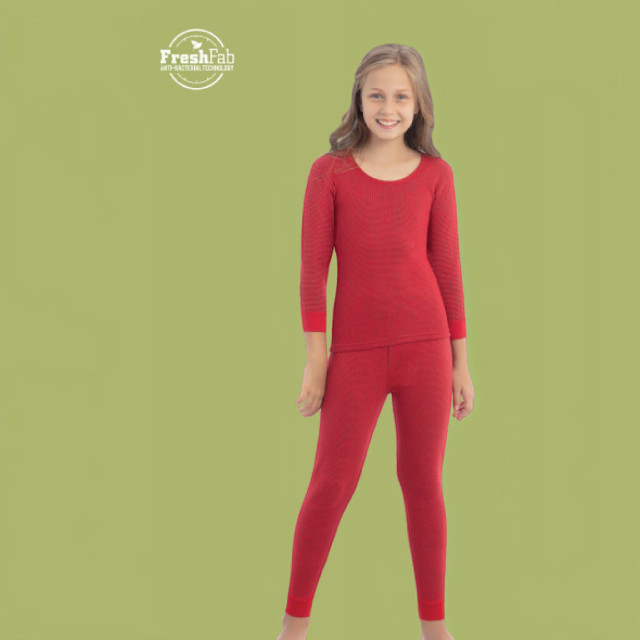 City Center Body Care Kids Art No. 303 red thermal base layer set worn by a smiling young girl on a green background