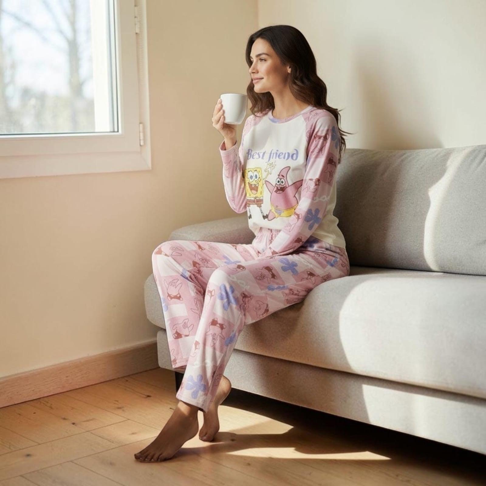 City Center Korean style co-ord set featuring SpongeBob and Patrick print on a woman sitting on a sofa with a mug.