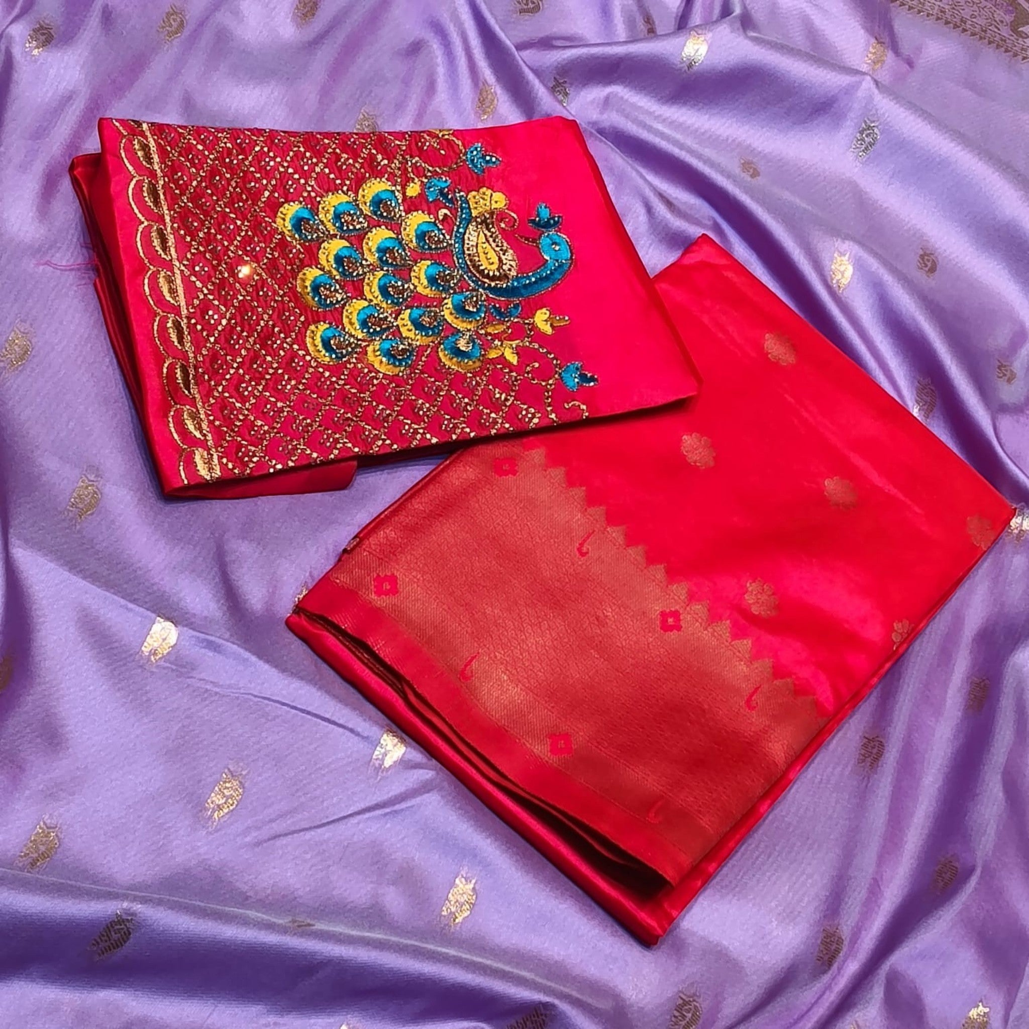City Center Kalanjali Chandrakala saree in lavender with a vibrant red blouse featuring intricate peacock Aari work.