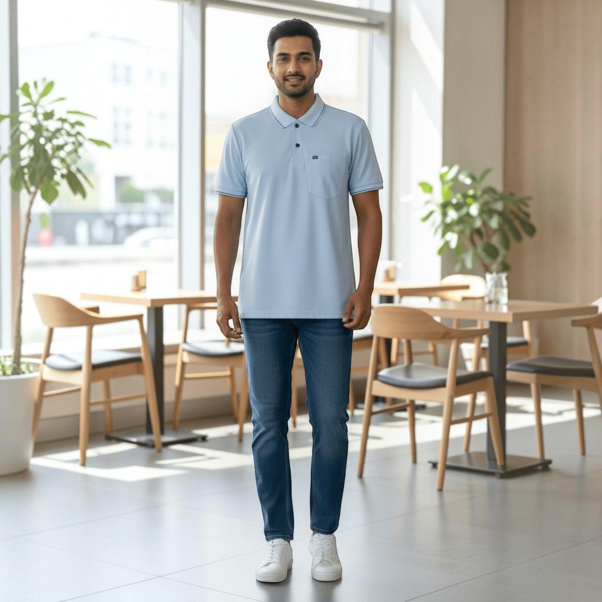 City Center men wearing a light blue cotton polo shirt with a chest pocket and dark blue jeans in a bright cafe.