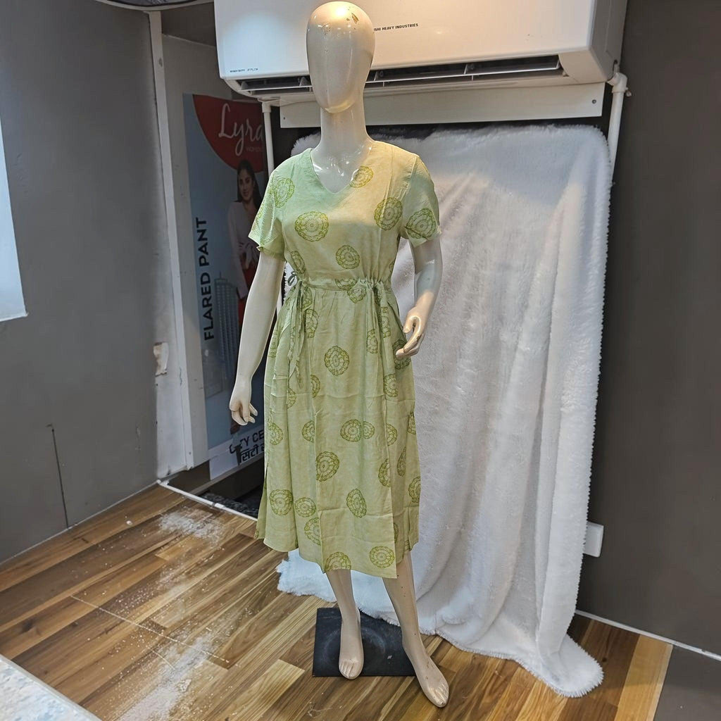 City Center light green midi dress with a v-neck, short sleeves, and circular geometric prints on a mannequin.