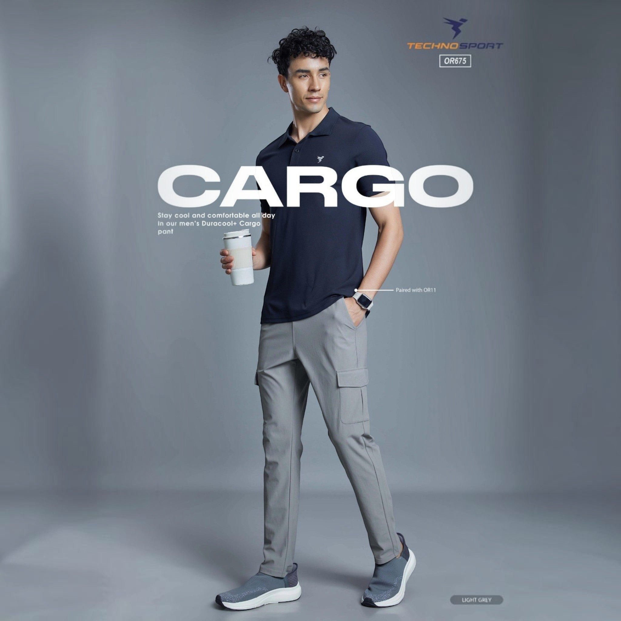 City Center model wearing light grey Technosport OR675 cargo track pants with a navy polo shirt and sneakers