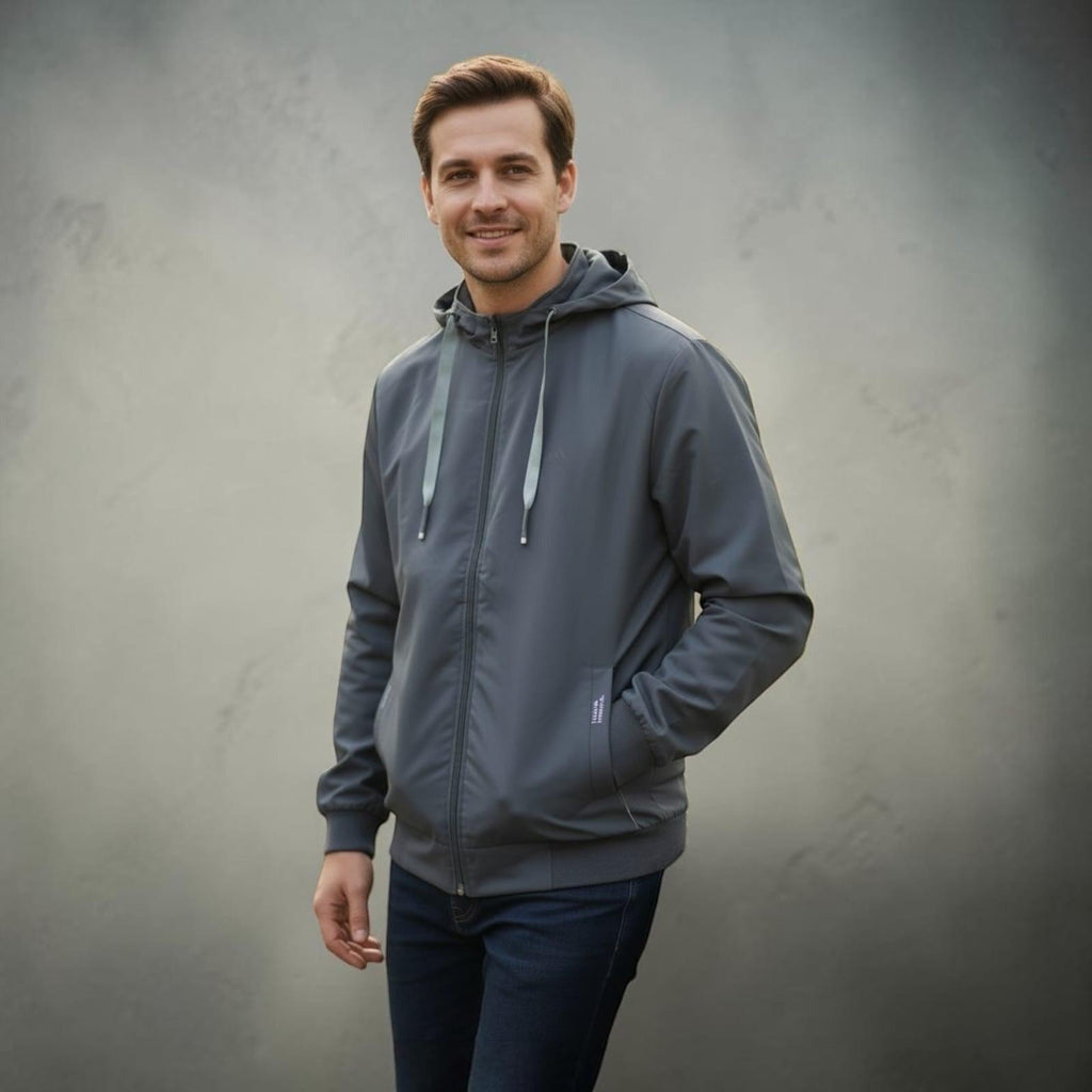 City Center light weight grey hooded jacket worn by a smiling man against a neutral background