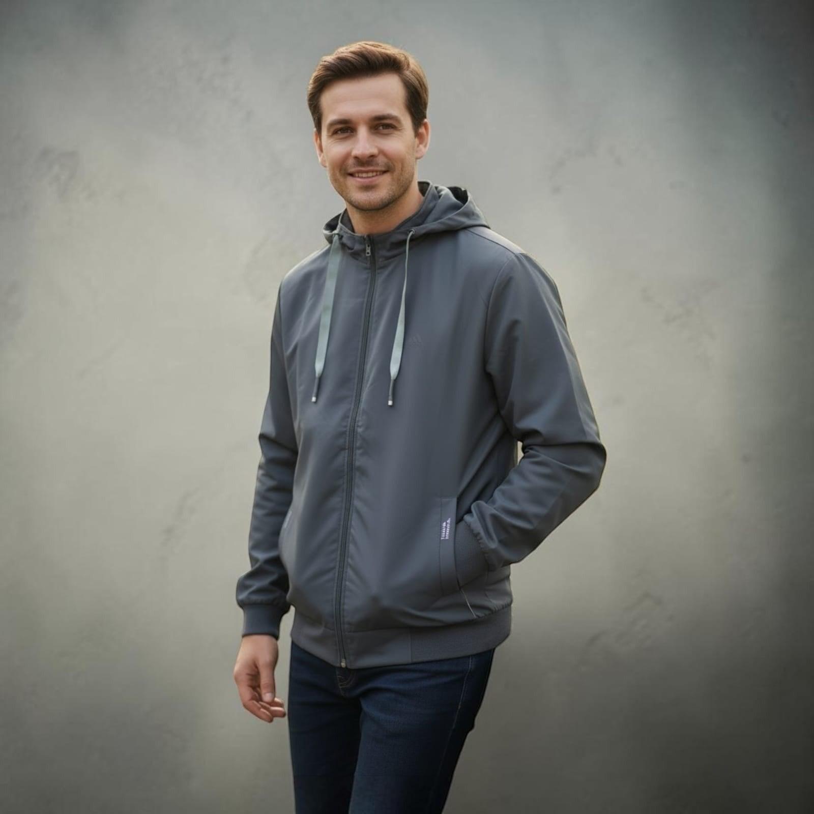 City Center light weight grey hooded jacket worn by a smiling man against a neutral background