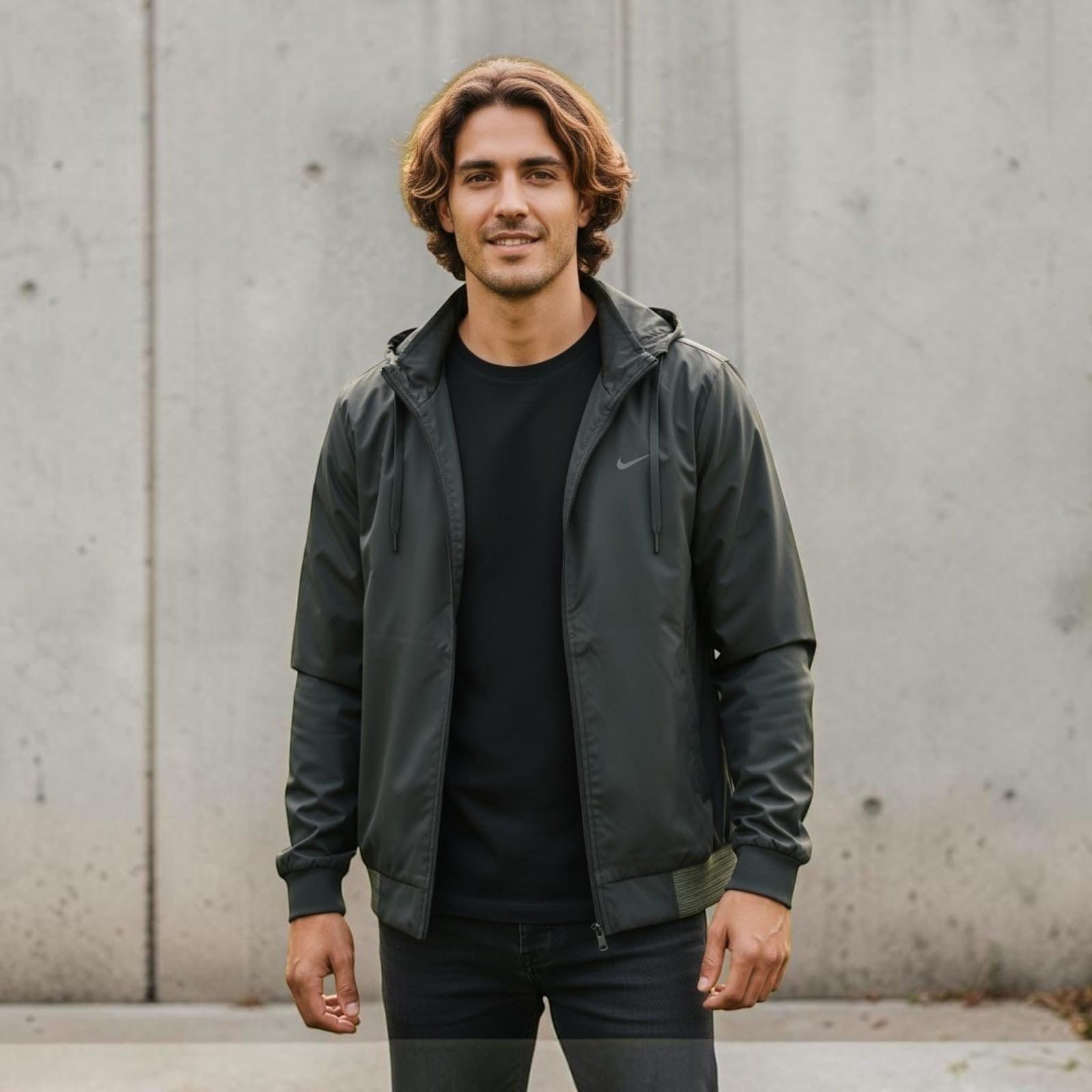 City Center premium lightweight dark green hooded jacket worn by a man against a concrete wall background