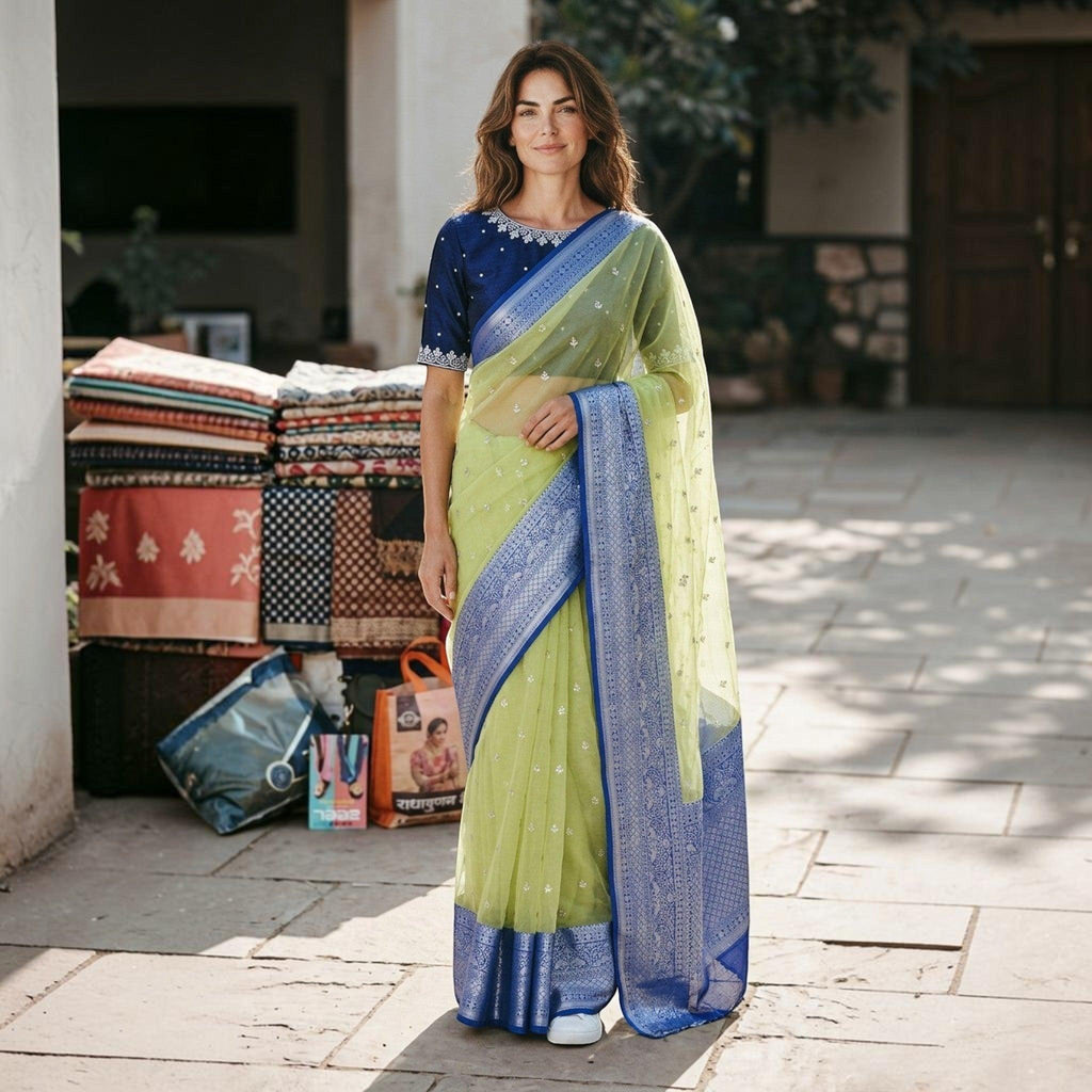 City Center organza saree in lime green with a deep blue embroidered blouse and intricate zari border