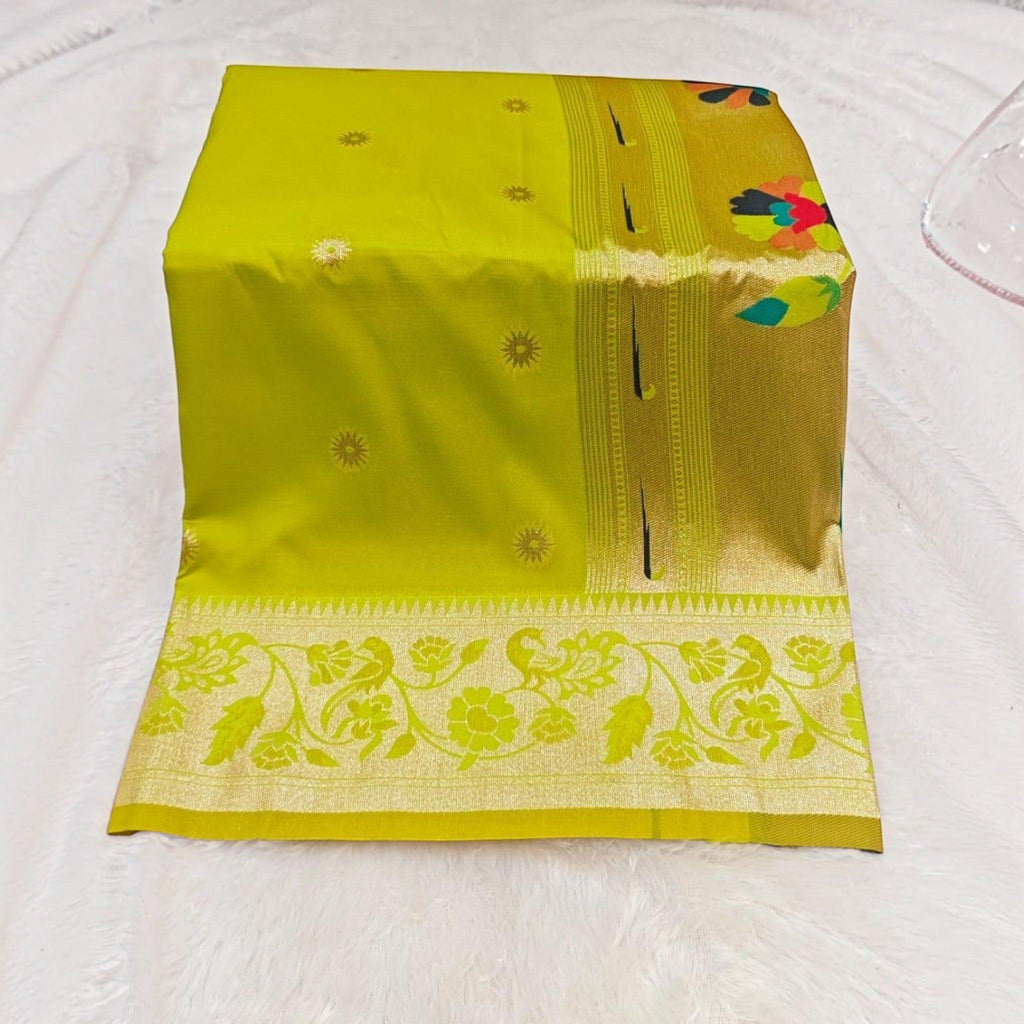 City Center lime green silk saree featuring a wide gold border with intricate floral and peacock woven patterns.