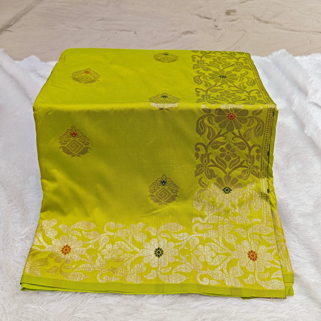 City Center Takshashila silk blend saree in lime green with gold zari floral motifs and colorful mina threadwork.