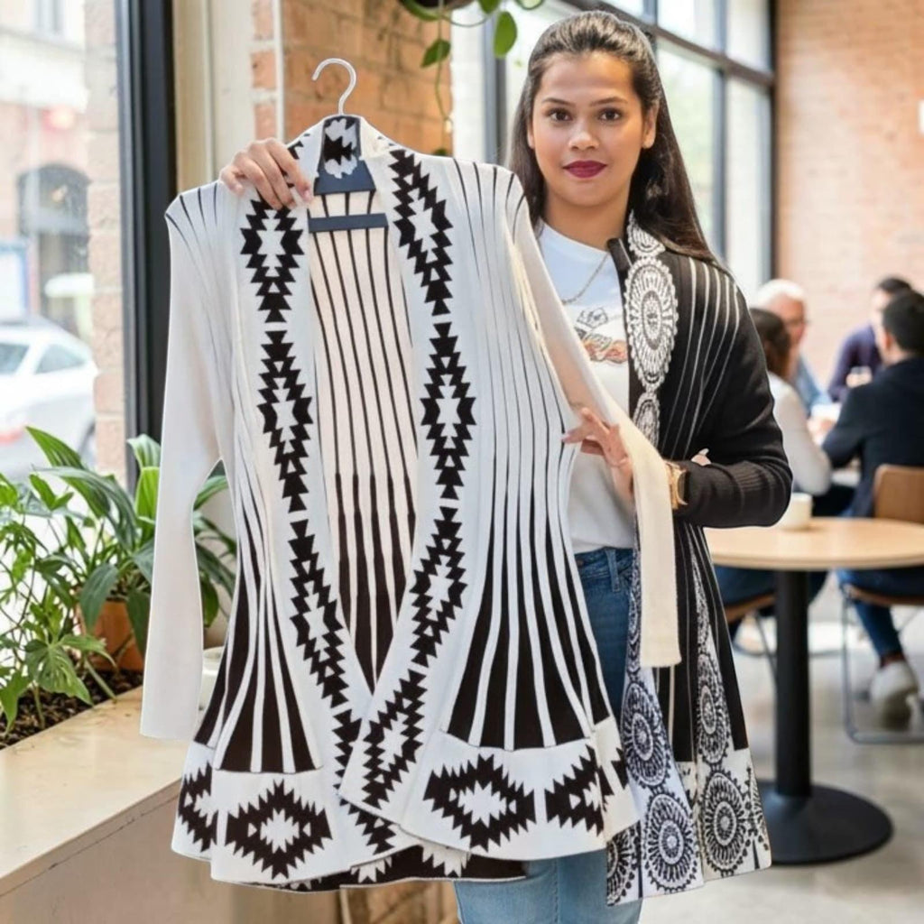 City Center long open front knit cardigan featuring a black and white geometric pattern in a cafe setting