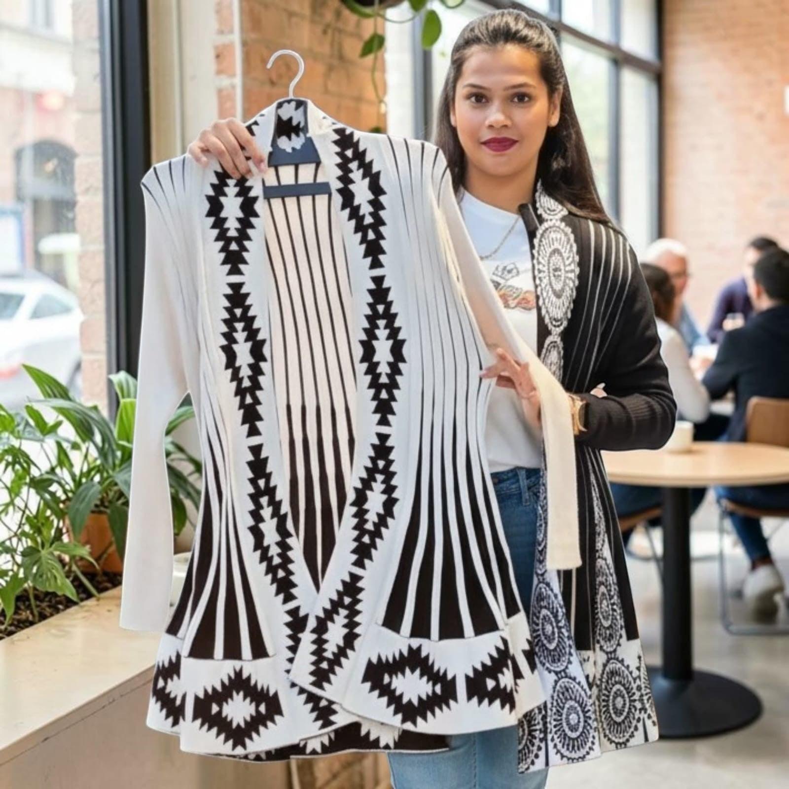 City Center long open front knit cardigan featuring a black and white geometric pattern in a cafe setting