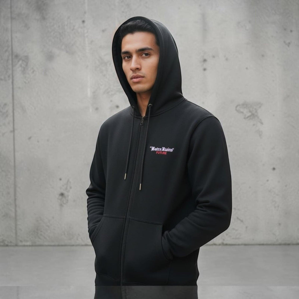 City Center M-LINE black zip-up hoodie worn by a man against a concrete wall, featuring a small chest logo.