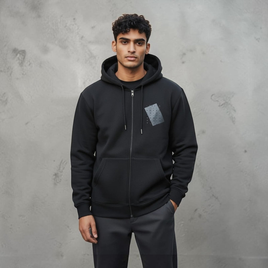 City Center M-LINE men's black full-zip hoodie with a subtle chest graphic, worn by a man against a grey background.