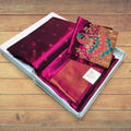City Center Kalanjali Aari work saree in deep magenta with intricate peacock embroidery and gold border in a gift box