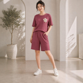 City Center women's maroon dry-fit co-ord set with short-sleeve top and shorts, featuring a floral chest detail.
