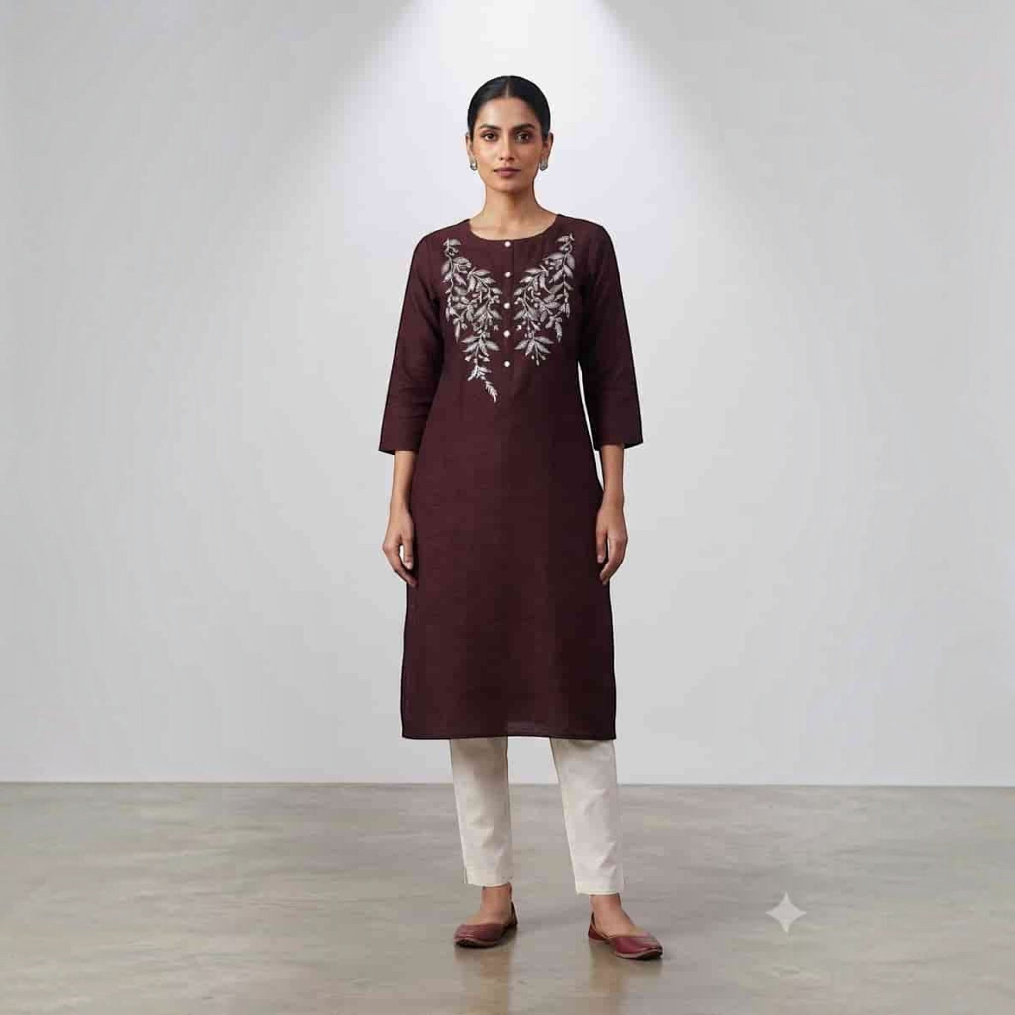 City Center Premium Lodgy Kurti in deep maroon with white floral embroidery, paired with cream trousers.