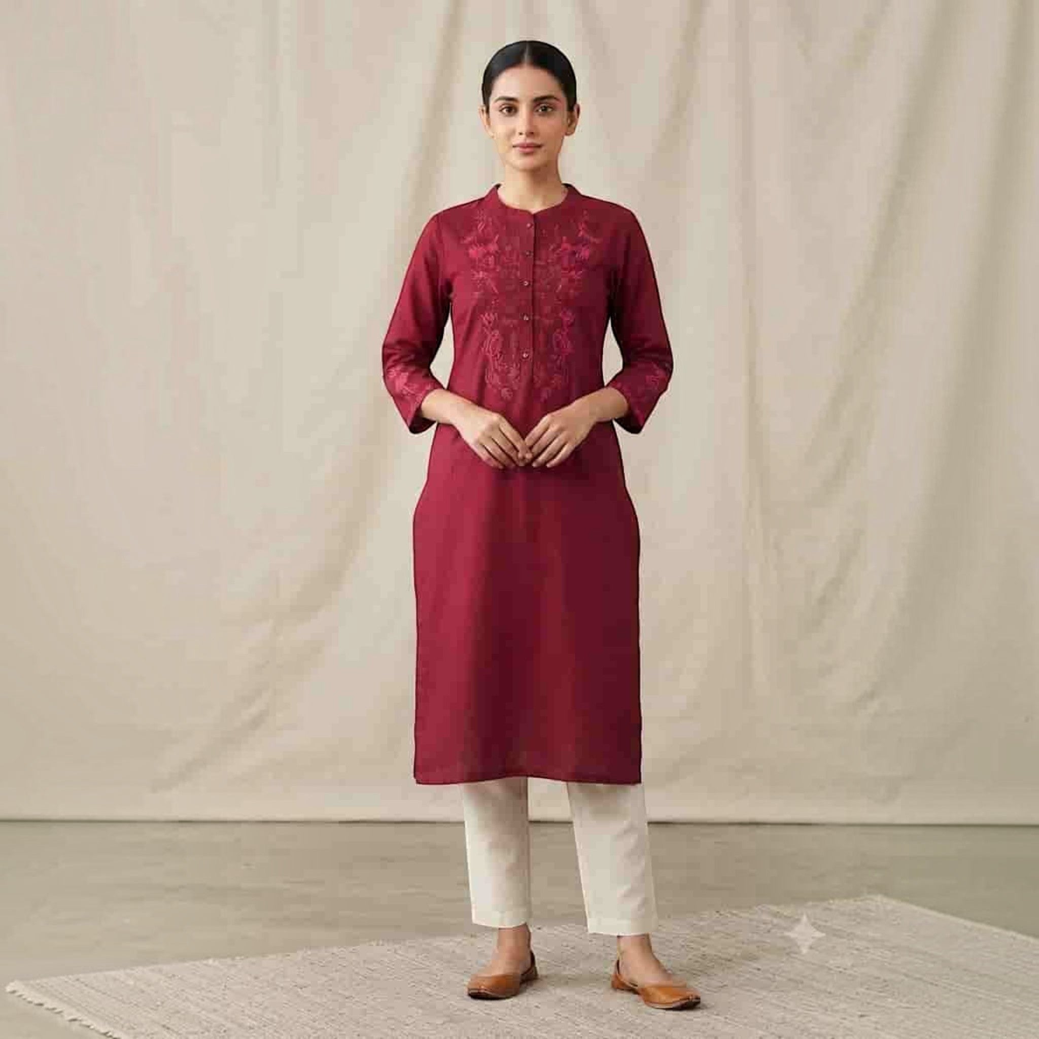 City Center maroon straight kurti with intricate embroidery and three-quarter sleeves paired with white trousers
