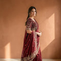 City Center designer maroon saree with a heavily embroidered velvet blouse featuring intricate gold thread work