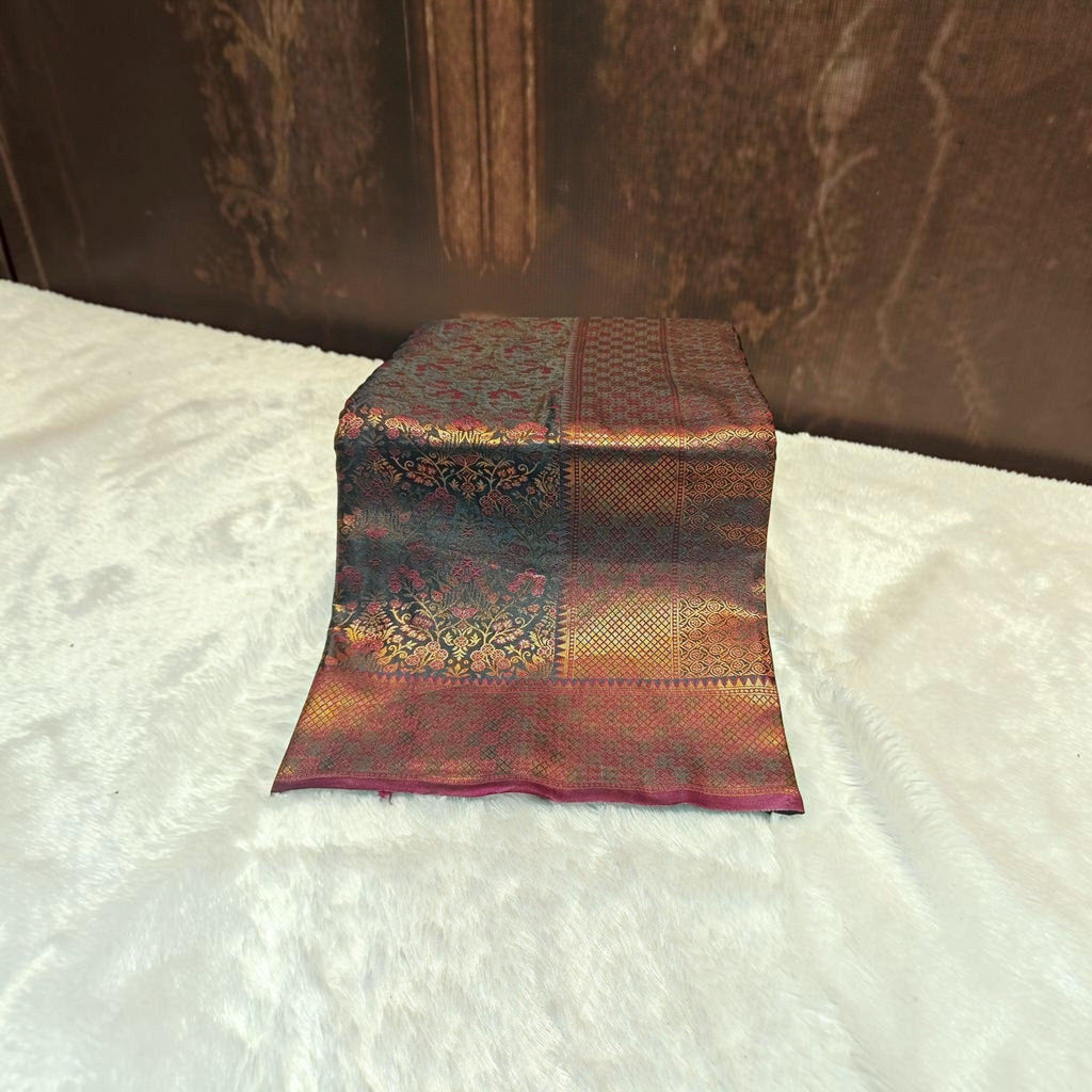 City Center satin silk saree featuring intricate floral and geometric gold zari patterns on a deep maroon fabric.