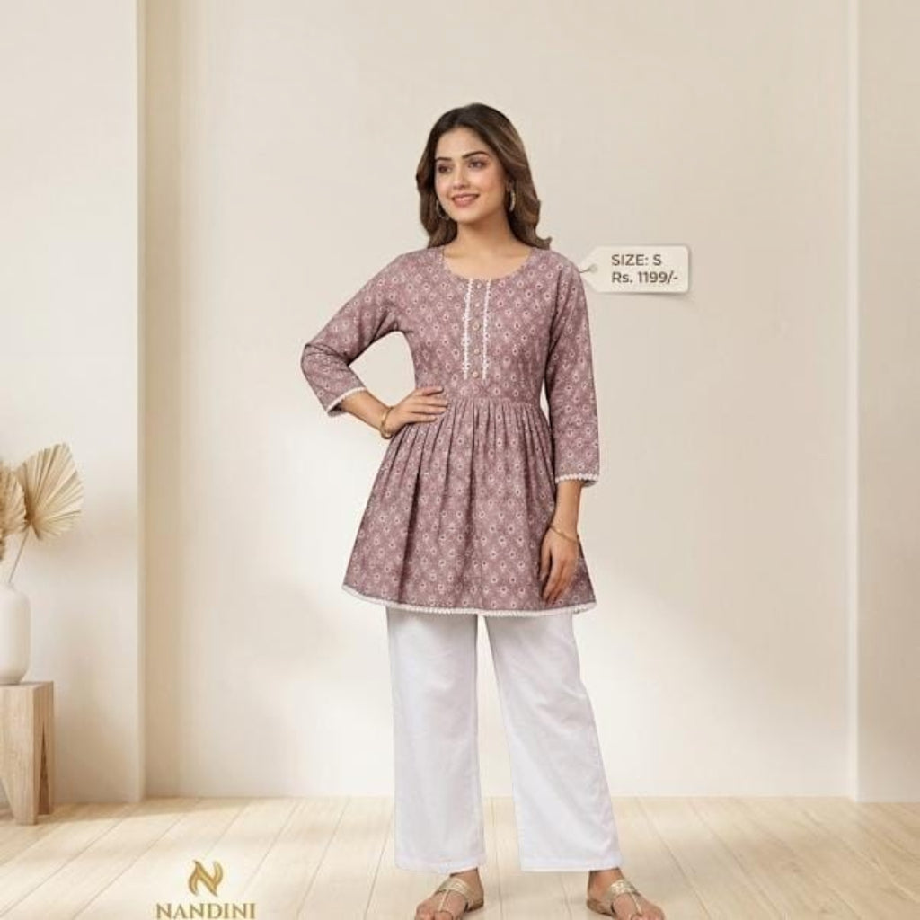 City Center premium mauve short kurti with floral print, three-quarter sleeves, and white lace trim, worn with pants.