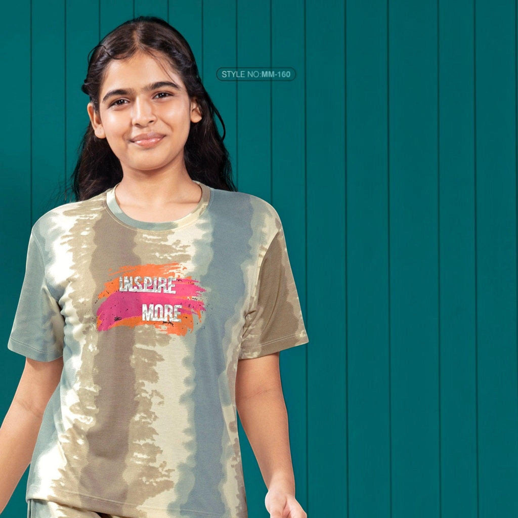 City Center Mawa Girl tie-dye t-shirt with Inspire More graphic print worn by a young girl against a teal background