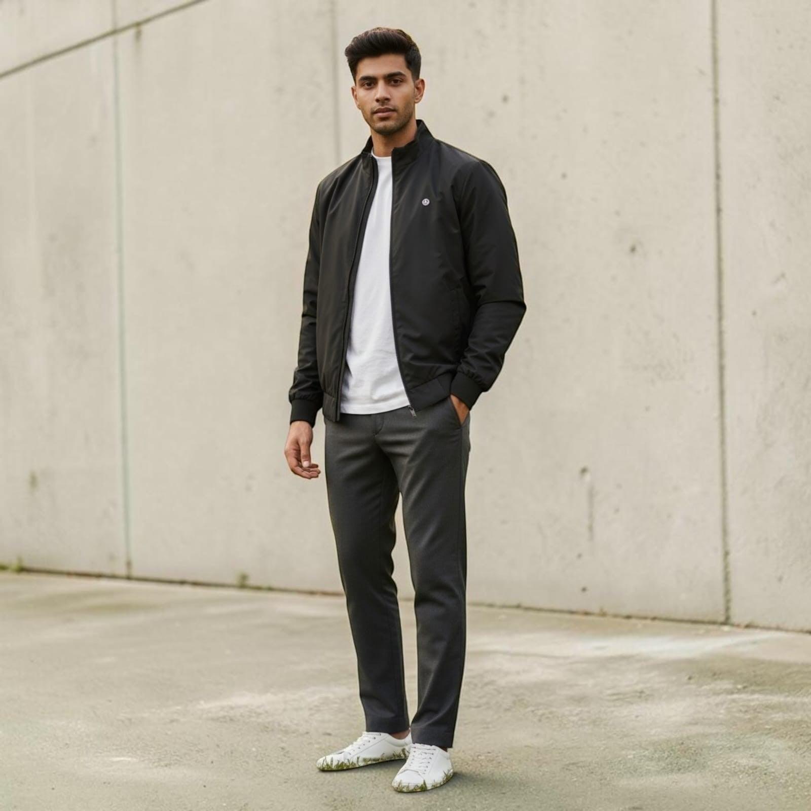 City Center men's black bomber-style zipper jacket worn over a white t-shirt with grey trousers and white sneakers.