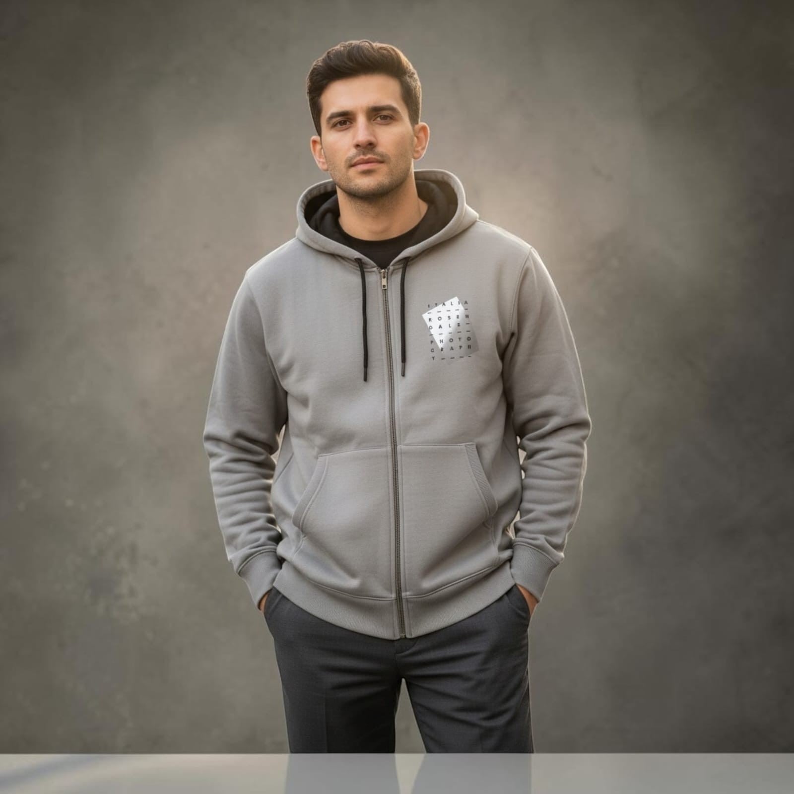 City Center M-LINE men's grey full-zip hoodie with kangaroo pockets worn by a man against a grey background