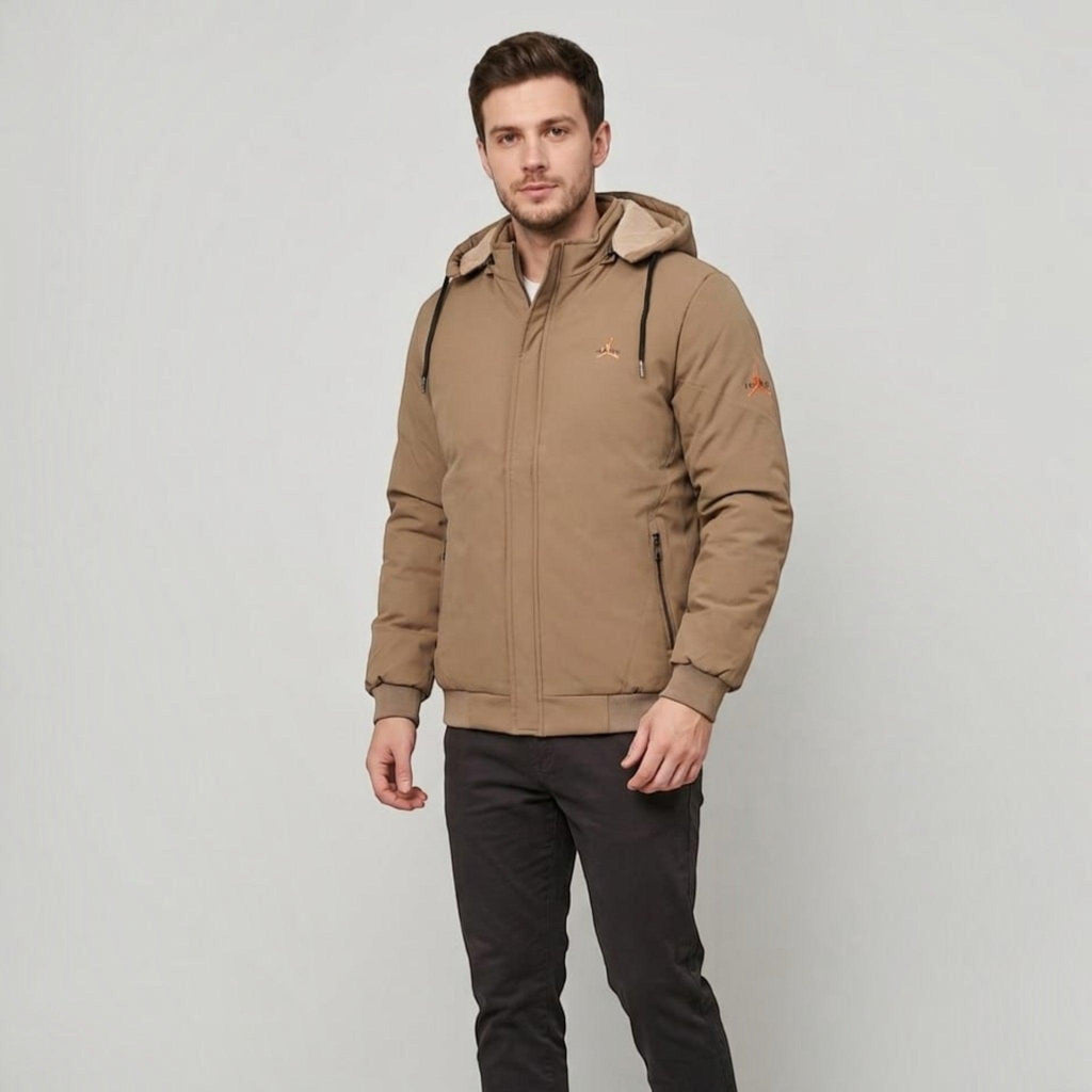 City Center men's tan weather-shield jacket with a detachable hood, woolen lining, and zippered pockets on a model.