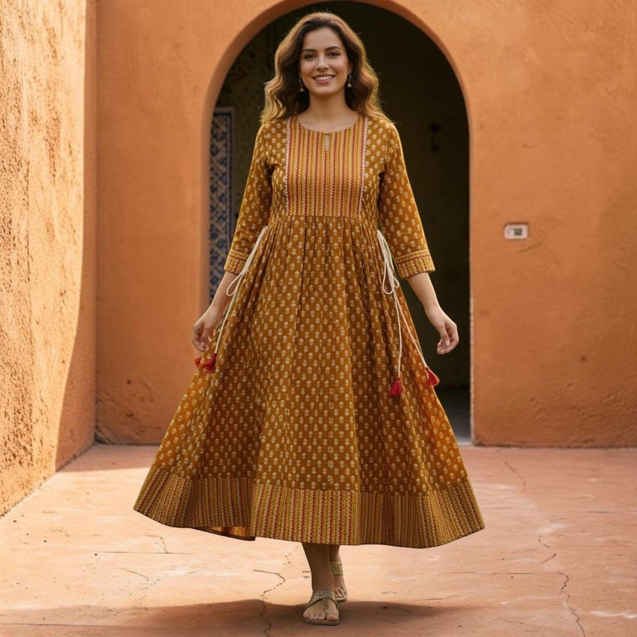 City Center Simra Anarkali Kurti in mustard yellow with intricate ethnic print and a flared silhouette on a woman