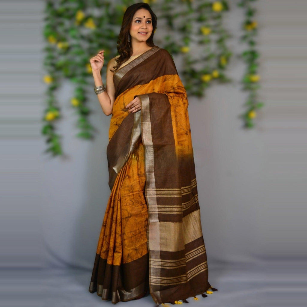 City Center premium cotton saree in mustard yellow and brown with batik print and a metallic border on a model