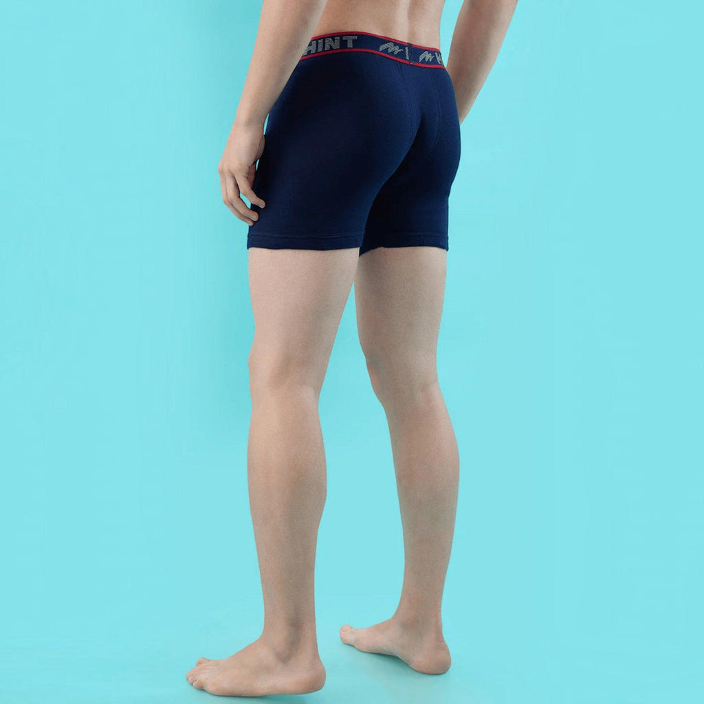 City Center men's navy blue stretch cotton long trunks with a branded elastic waistband, back view.