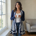 City Center long open front knit cardigan in navy blue with white geometric patterns, worn by a woman indoors.