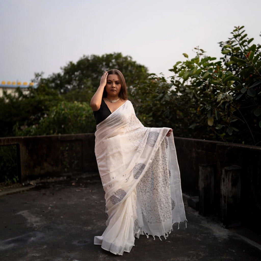 City Center premium cotton saree in off-white with grey floral motifs, worn by a model on a rooftop terrace.