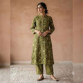 City Center olive green floral print kurta and striped trouser co-ord set worn by a woman with a refined silhouette