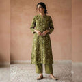 City Center olive green floral print kurta and striped trouser co-ord set worn by a woman with a refined silhouette