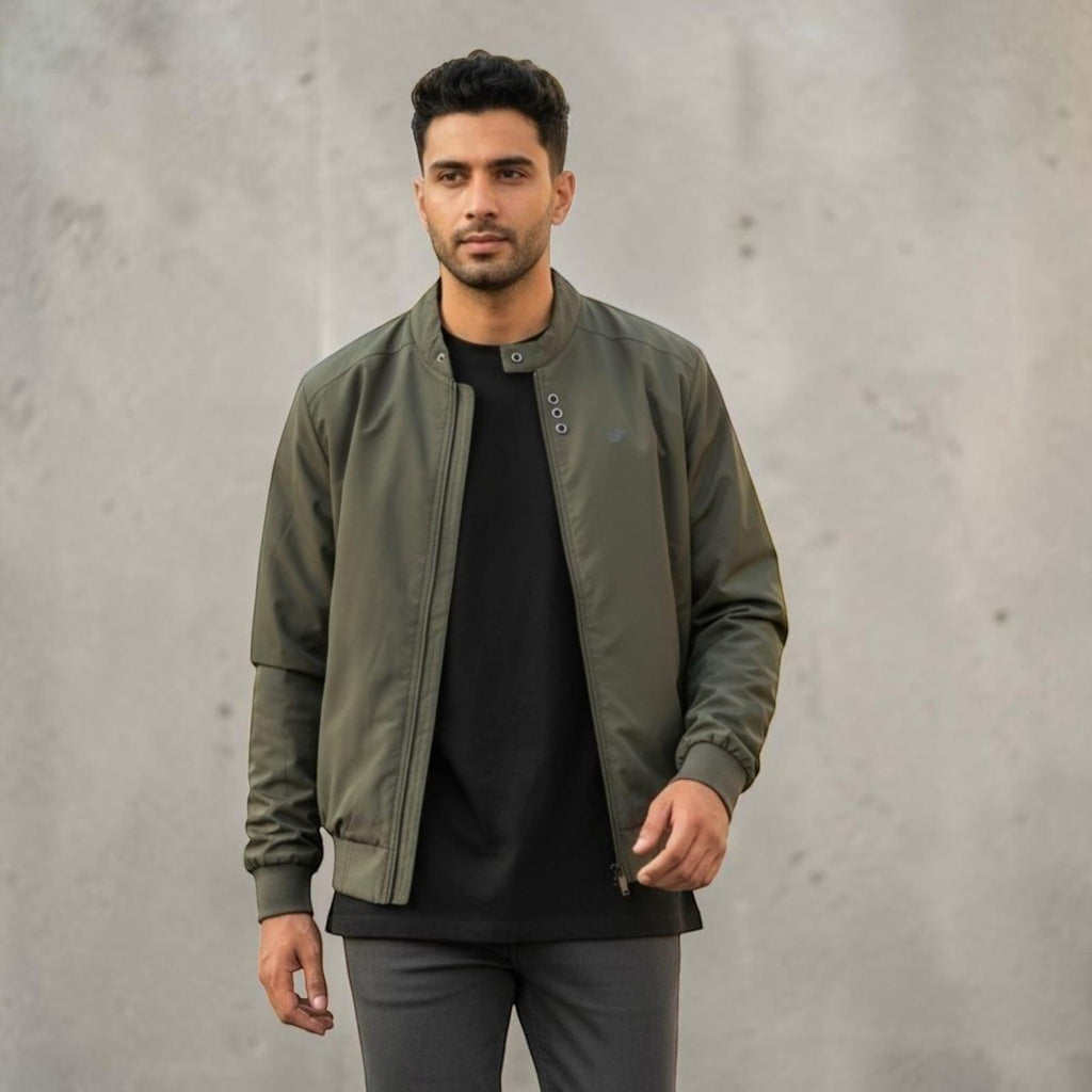 City Center olive green full-zip casual jacket worn by a man over a black t-shirt against a concrete wall background
