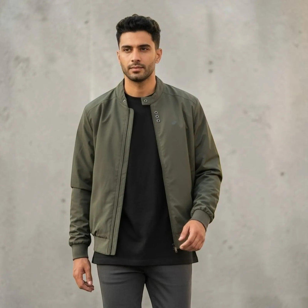 City Center olive green full-zip casual jacket worn by a man over a black t-shirt against a grey concrete wall