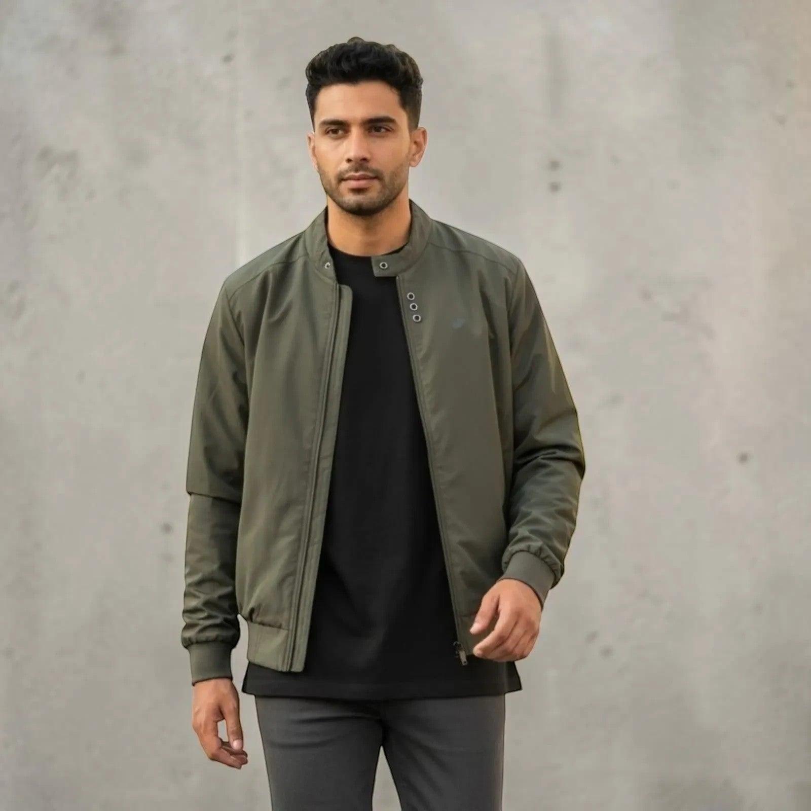 City Center olive green full-zip casual jacket worn by a man over a black t-shirt against a grey concrete wall