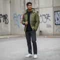 City Center olive green quilted hooded bomber jacket worn by a man with a black shirt and grey trousers