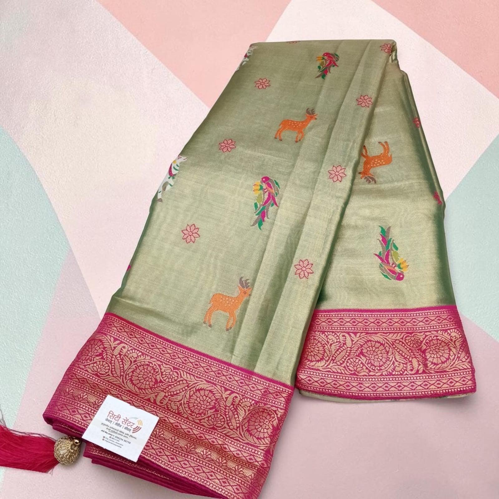 City Center olive green tissue saree with pink zari border and traditional deer and floral motifs
