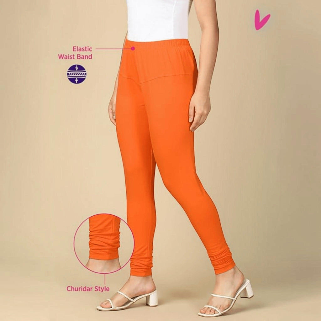 City Center orange cotton lycra churidar leggings for women with an elastic waistband and gathered ankle detail.