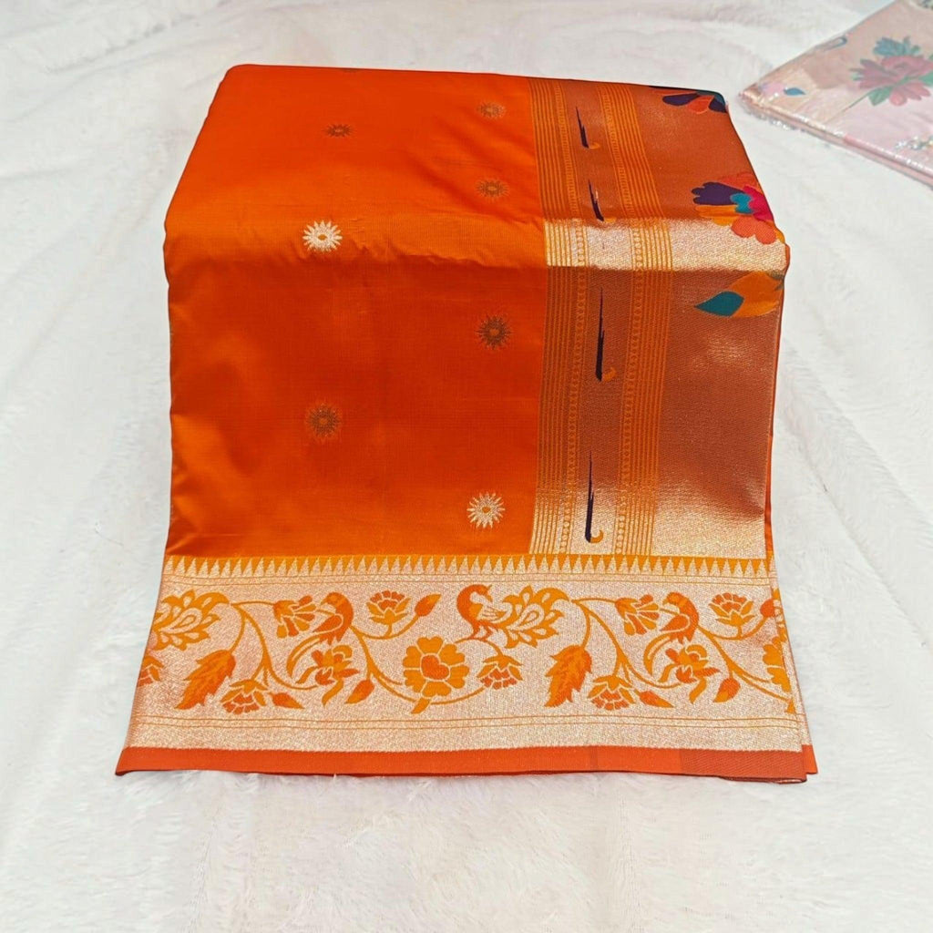 City Center orange silk saree with gold floral motifs and an intricate peacock patterned border.