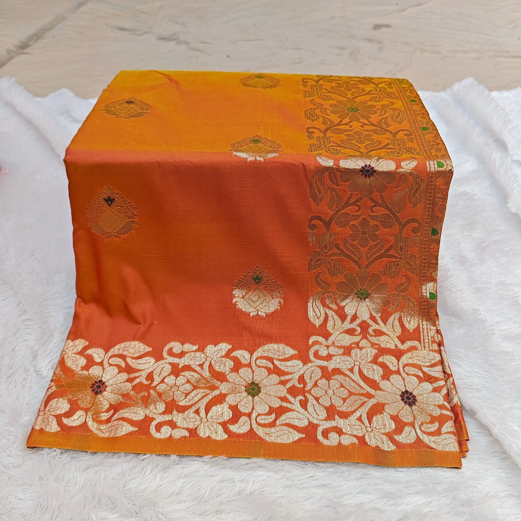 City Center Takshashila silk blend saree in orange with intricate gold zari and multi-color mina floral weave.