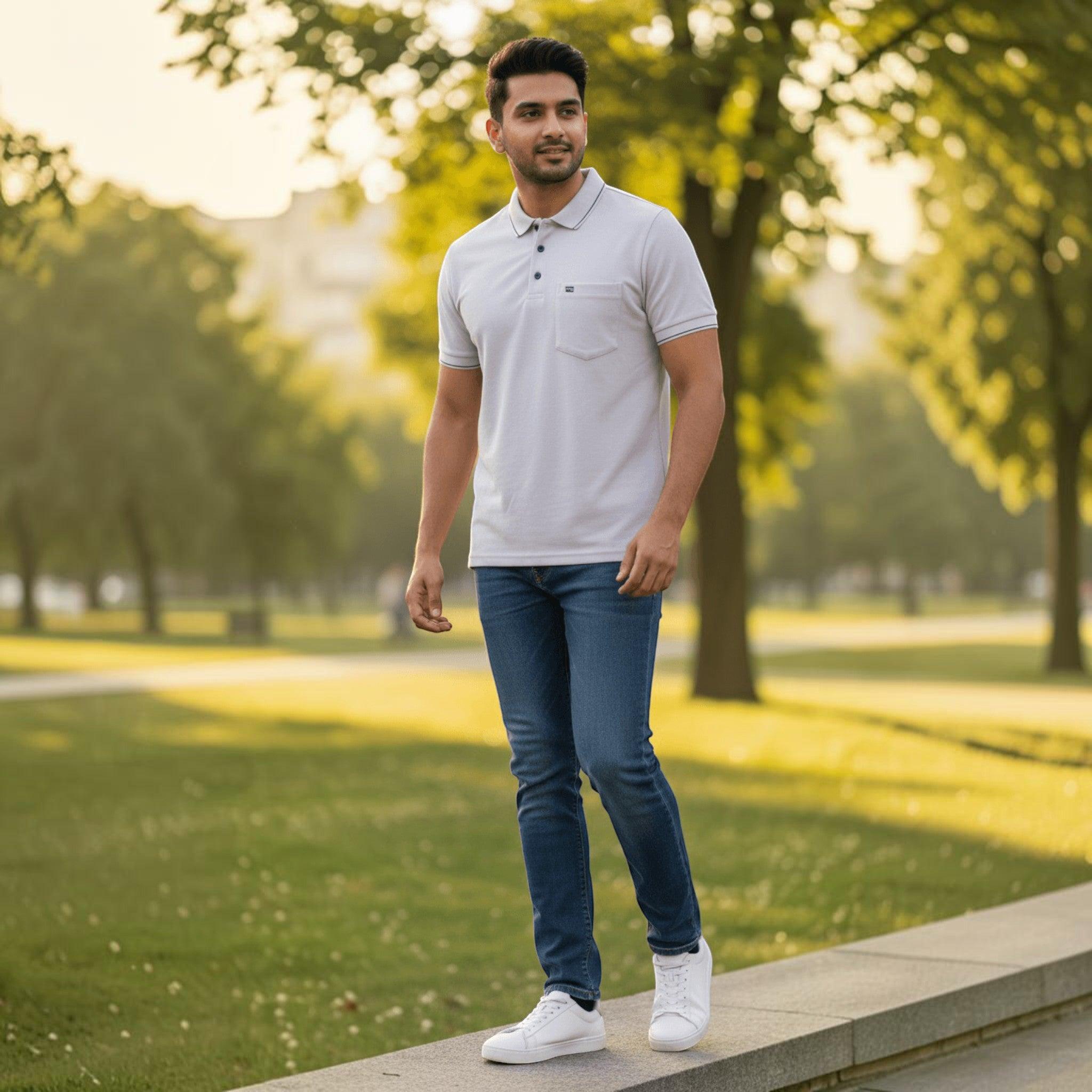 City Center men's light pastel polo shirt with chest pocket and blue jeans worn by a man in a park