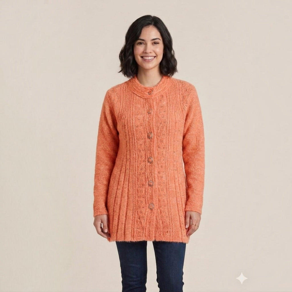 City Center woman wearing a long-sleeved peach cable-knit button-down cardigan sweater with a round neckline.