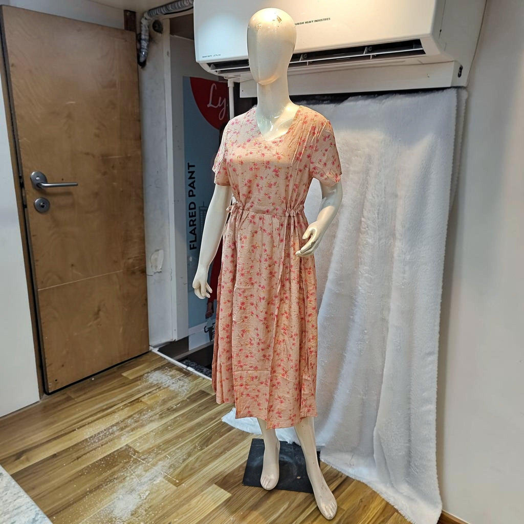 City Center peach floral midi dress with a cinched waist and short sleeves on a mannequin